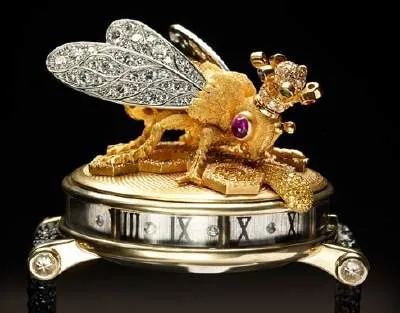 A timeless gold and diamond watch with a bug on it from Zadora Timepieces.