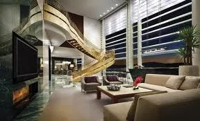 A living room with a fireplace and a spiral staircase, showcasing the exotic skyline of Las Vegas!
