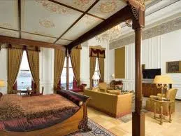 An ornately decorated bedroom with a four poster bed fit for a Sultan at Grand Sultan Suite, The Ciragan Palace Hotel Kempinski.