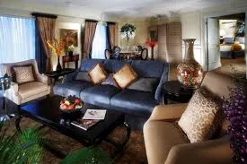 A living room with couches and a coffee table in The Venetian Macau suites.