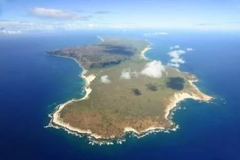 An aerial view of an island getaway in the ocean, Hawaiian-style.
