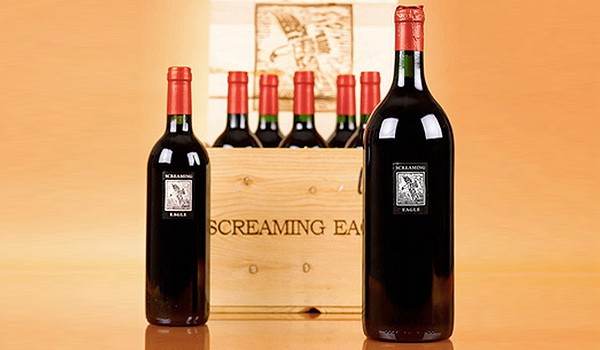 Five bottles of red wine in a wooden crate - Vintage Wine.