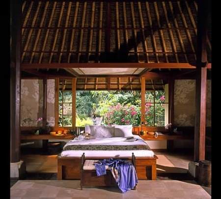 Discover Amandari Resort Hotel nestled in the Bali forests offering luxurious bedrooms with comfortable beds and elegant bedside tables.