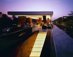 Experience Thai aristocracy at The Hotel Cha-Am, a tropical resort with stairs leading to a pool at dusk.