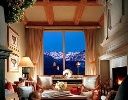 A luxurious living room with a fireplace and stunning mountain views.