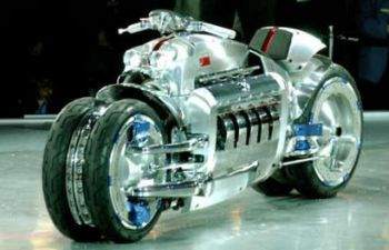 A valuable silver motorcycle is on display at a show.