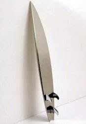 Designer surfboard on white wall.