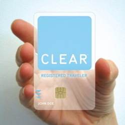 A person holding up a card that says "clear registered traveler" amidst the closure of FlyClear.