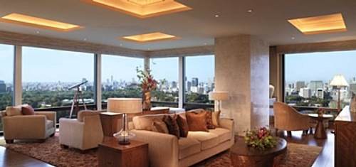 A living room with large windows overlooking a city.