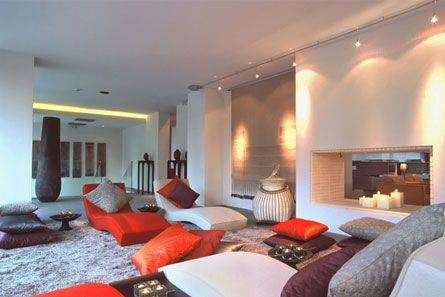 A living room with couches and a fireplace in Athen's Life Gallery.