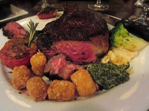 A plate with beef steak and vegetables on it at the Old Homestead Steakhouse.
