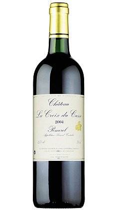 A bottle of Petrus red wine on a white background.