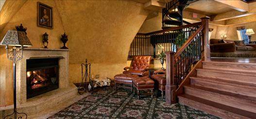 A luxurious living room with a fireplace and stairs in the Fairmont Banff Springs hotel - A luxurious package.