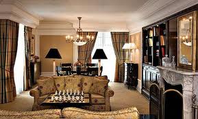 A luxurious living room with a fireplace and chess board.
