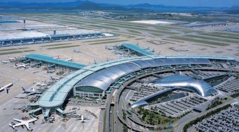 An aerial view of an airport with airplanes and planes in Asia.