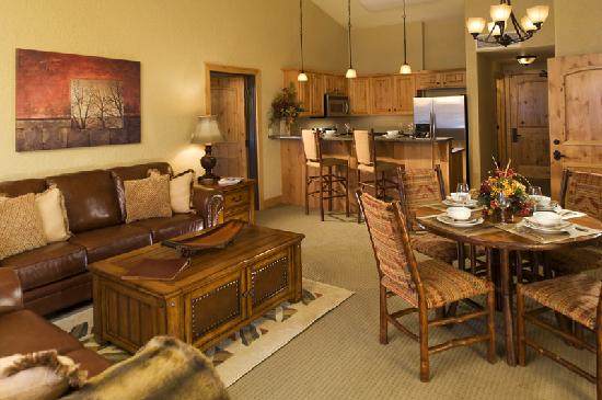 A living room with a kitchen and dining area in a snow-covered dreamland.