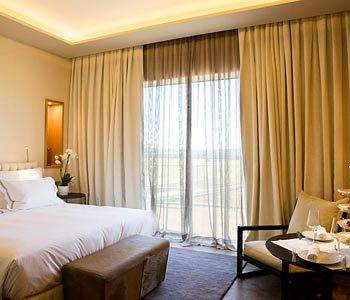 A bed or beds in a room at Valbusenda Hotel Resort & Spa.